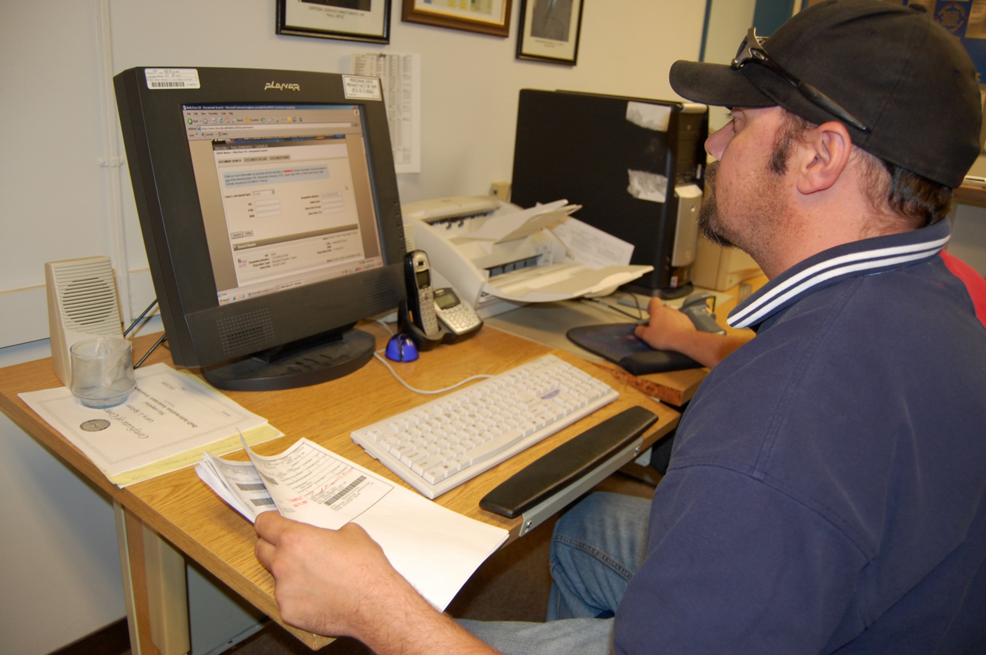 Larry Spitzer, Malmstrom Defense Reutilization and Management Office general clerk, uploads government property into the Webdocs, DRMS's online tracking system. (U.S. Air Force photo/Tech. Sgt. Marcus McDonald)