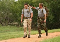 Master Sgt. Kenneth Huhman (right) helps 1st Lt. Sam Schindler with his ruck sack at the Lackland Training Annex Sept. 24. On Oct. 6, 12 Airmen will leave the Lackland Training Annex at 5 a.m. to begin a ruck march to Hurlburt Field, Fla., in honor of 12 fallen special tactics Airmen killed in Iraq and Afghanistan. (U.S. Air Force photo/Robbin Cresswell) 