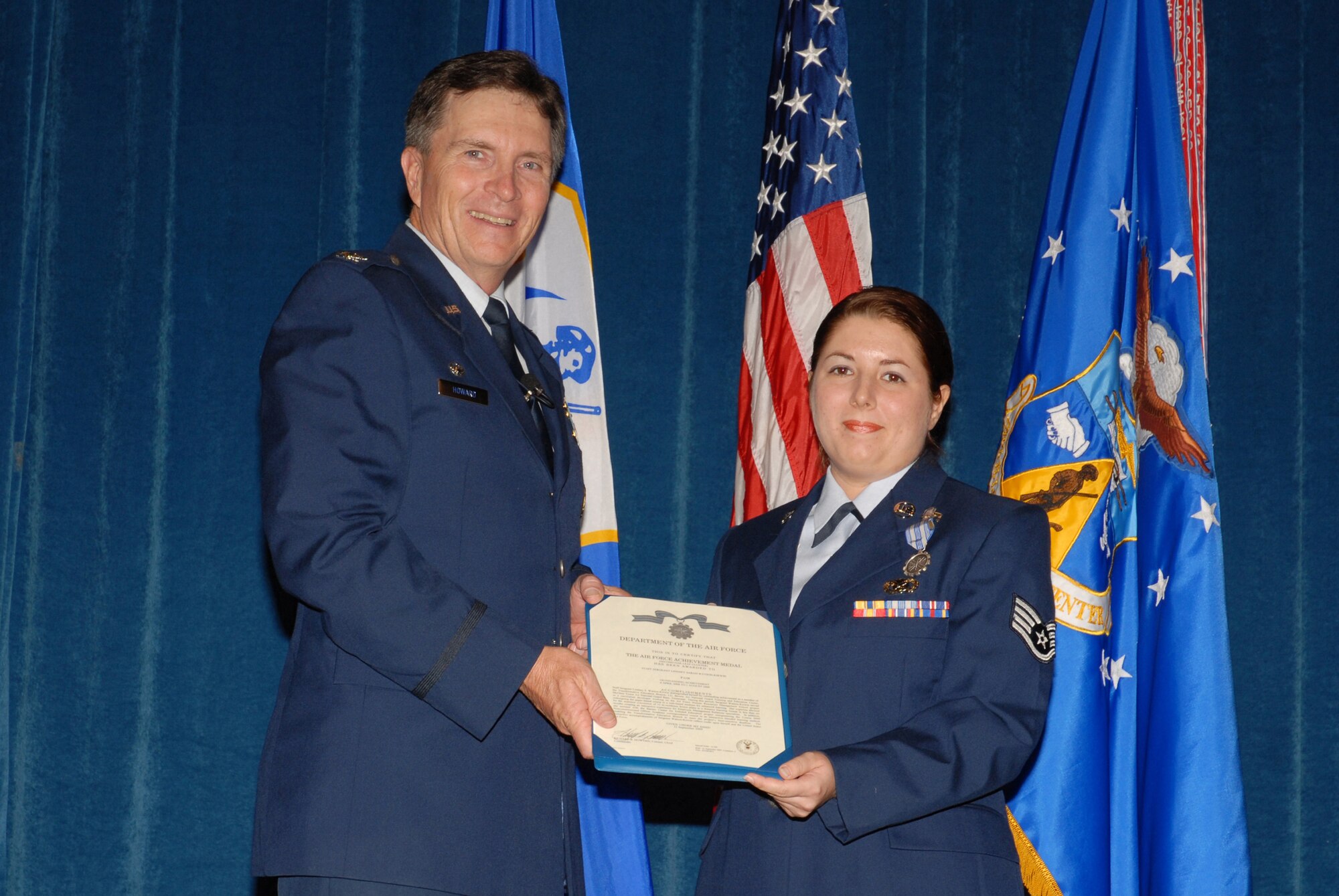 McGHEE TYSON ANGB, Tenn. -- Col. Richard B. Howard, commander, presents the Air Force Achievement Medal to Staff Sgt. Lindsey Sarah Watson-Kirwin, a public affairs journalist with the 134th Air Refueling Wing who is assisting the Transformative Education branch as a curriculum developer, during commander's call on the campus of The I.G. Brown Air National Guard Training and Education Center here, Sept. 25, 2009.  Watson-Kirwin distinguished herself from April 6 to Aug. 1, 2009 while assigned to the Training and Education Center. (U.S. Air Force photograph by Master Sgt. Mavi Smith)