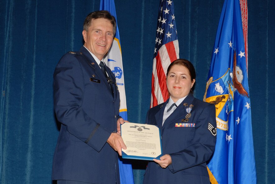 Col. Richard B. Howard, TEC commander, presents the Air Force Achievement Medal to Staff Sgt. Lindsey Watson-Kirwin, a public affairs journalist with the 134th Air Refueling Wing.