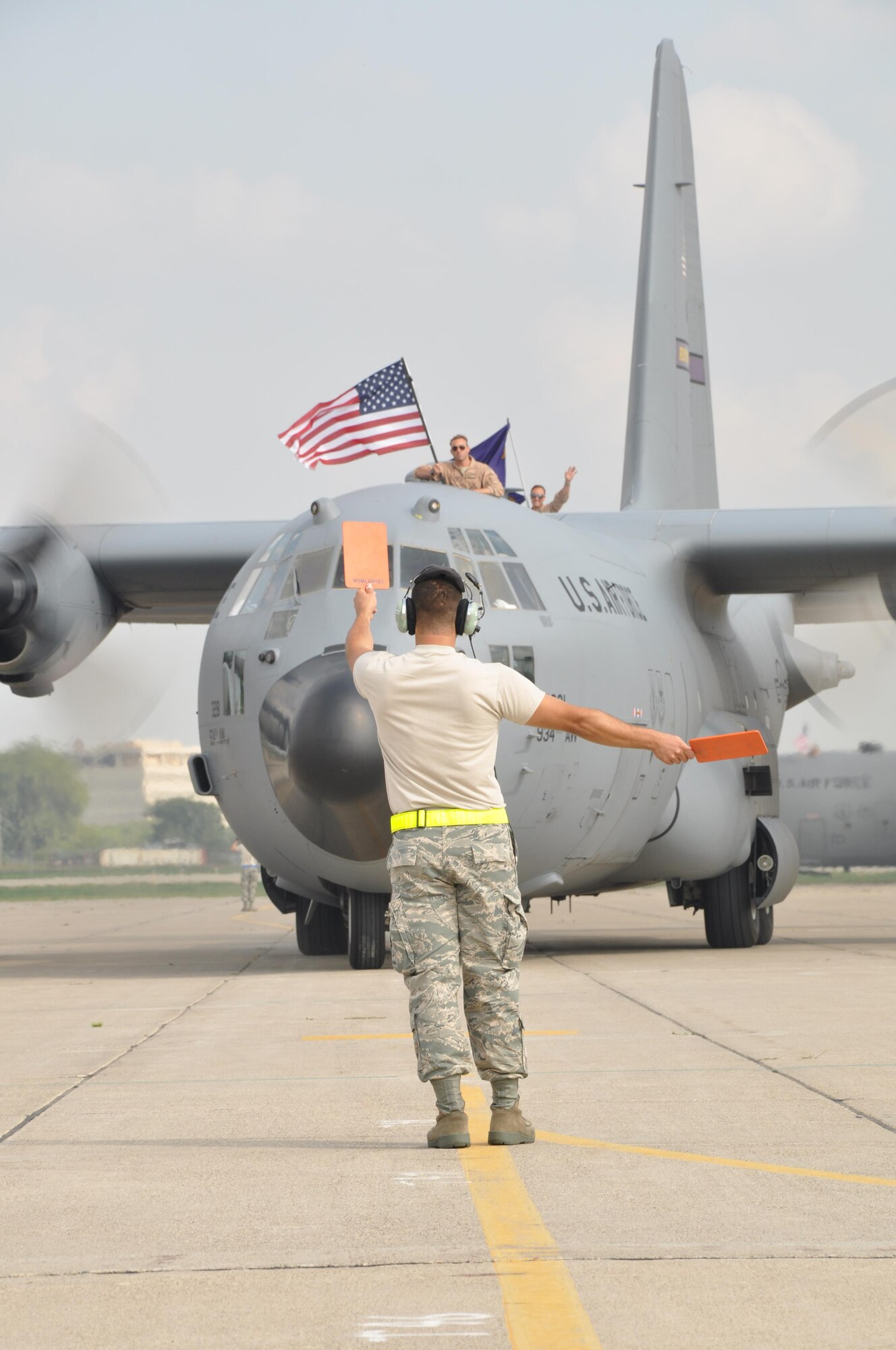 Capt. Chris Rieland, 934th Operations Support Flight (front) and Tech. Sgt. Cory Preusse, 96th Airlift Squadron wave to family and friends as they return from their Southwest Asia deployment. About 150 934th members returned Sept. 11. See story on page 3.