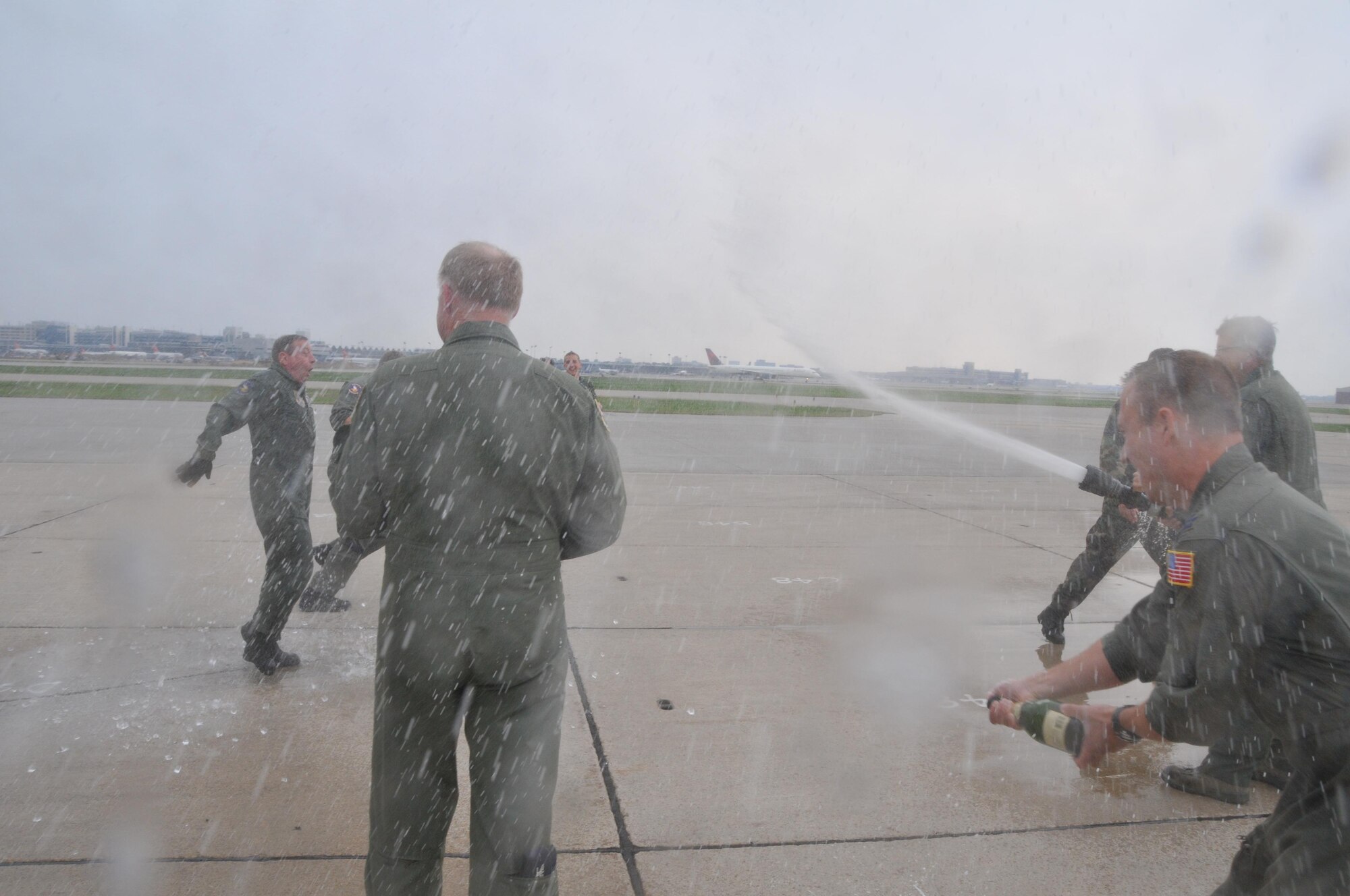 Chief Master Sgt. Tom Foss, 96th Airlift Squadron, gets the traditional hose down after his final flight as chief loadmaster. Foss has too many years of service for anyone to calculate. (Air Force photo/Master Sgt. Paul Zadach)