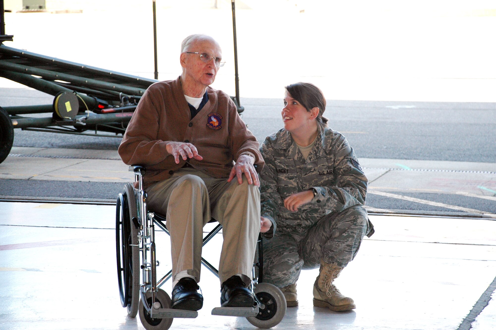 Staff Sgt. Kara Sundet, a 934th Aeromedical Staging Squadron medical technician, listens to Art Erickson, a World War II Navy Veteran, talk about his time in the service at the 934th Airlift Wing?s annual ?Take-A-Vet-To-Lunch? Day Sept. 17 at the Minneapolis-St. Paul IAP Air Reserve Station. (U.S. Air Force photo by Capt. S.J. Brown)
