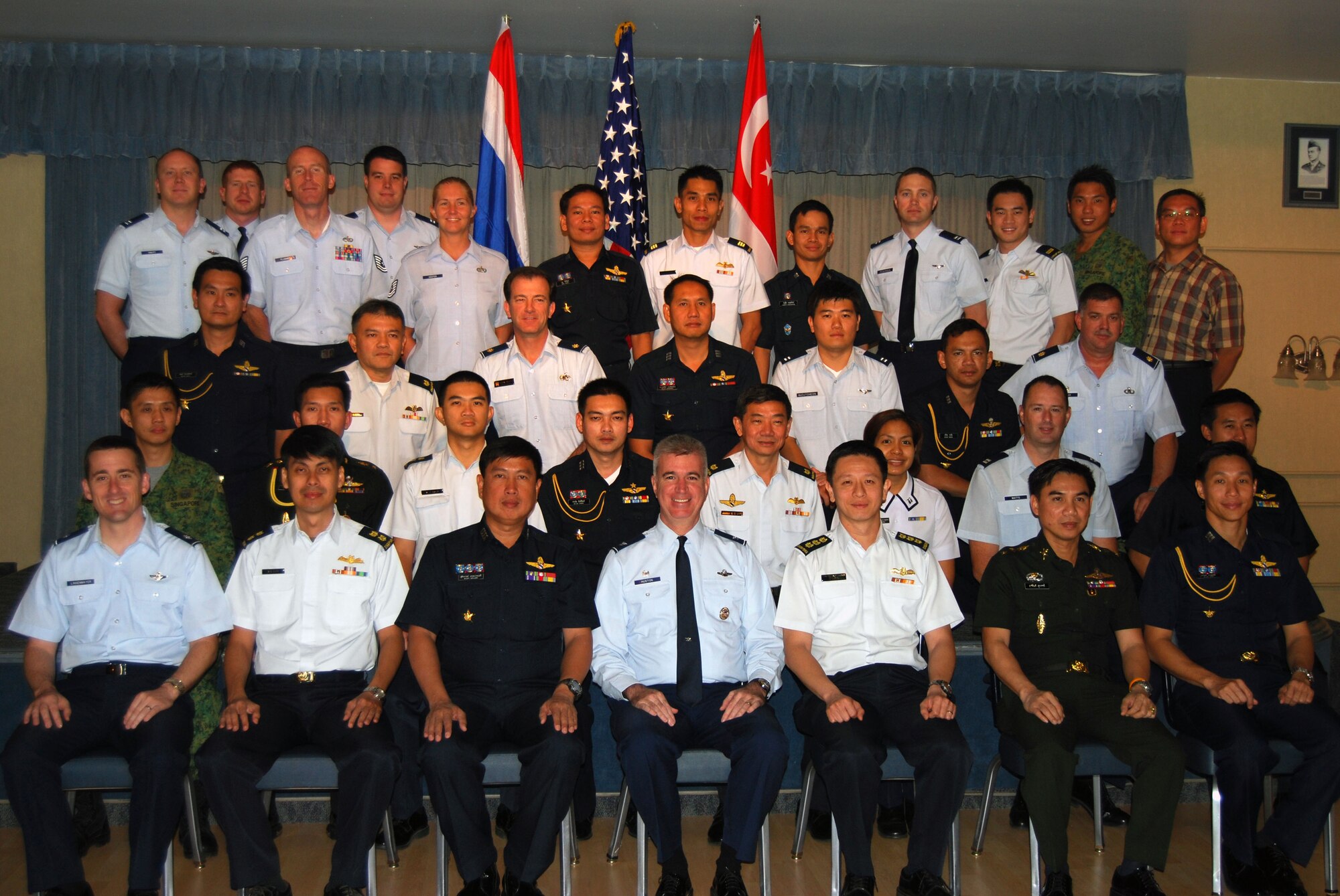 Representatives from Thailand, Singapore and the United States armed forces gather for a group photo after working out the details for the upcoming Cope Tiger exercise in Thailand in March 2010 at a conference held Sept 21-25 at Elemendorf Air Force Base, Alaska. Cope Tiger is an annual, multilateral aerial exercise which divides Thai, Singaporean and U.S. Air Force, Navy and Marine Corps aircraft into two mixed groups, pitting them against each other in a mock battle. The exercise also includes a two-phase humanitarian and civic assistance portion (Courtesy photo)