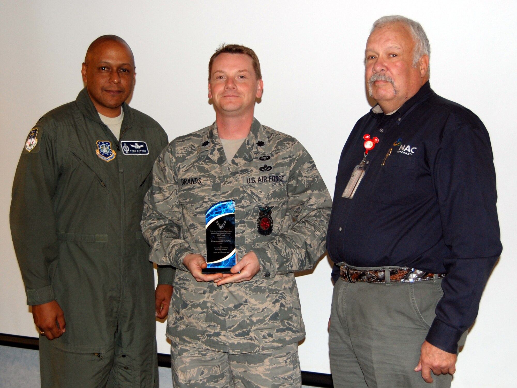 Lt. Col. Joseph Brands, 341st Civil Engineer Squadron commander (center), poses with Col. Anthony Cotton, 341st Missile Wing vice commander (left) and Kent Seaton, base energy manager, prior to the start of the Energy Management Steering Group meeting Sept. 11. Malmstrom was one of three bases in the Air Force to win the Reducing Energy Appreciation Program Award in fiscal year 2008 for having the highest enegry reduction improvement. (U.S. Air Force photo/Tech. Sgt. Marcus McDonald)