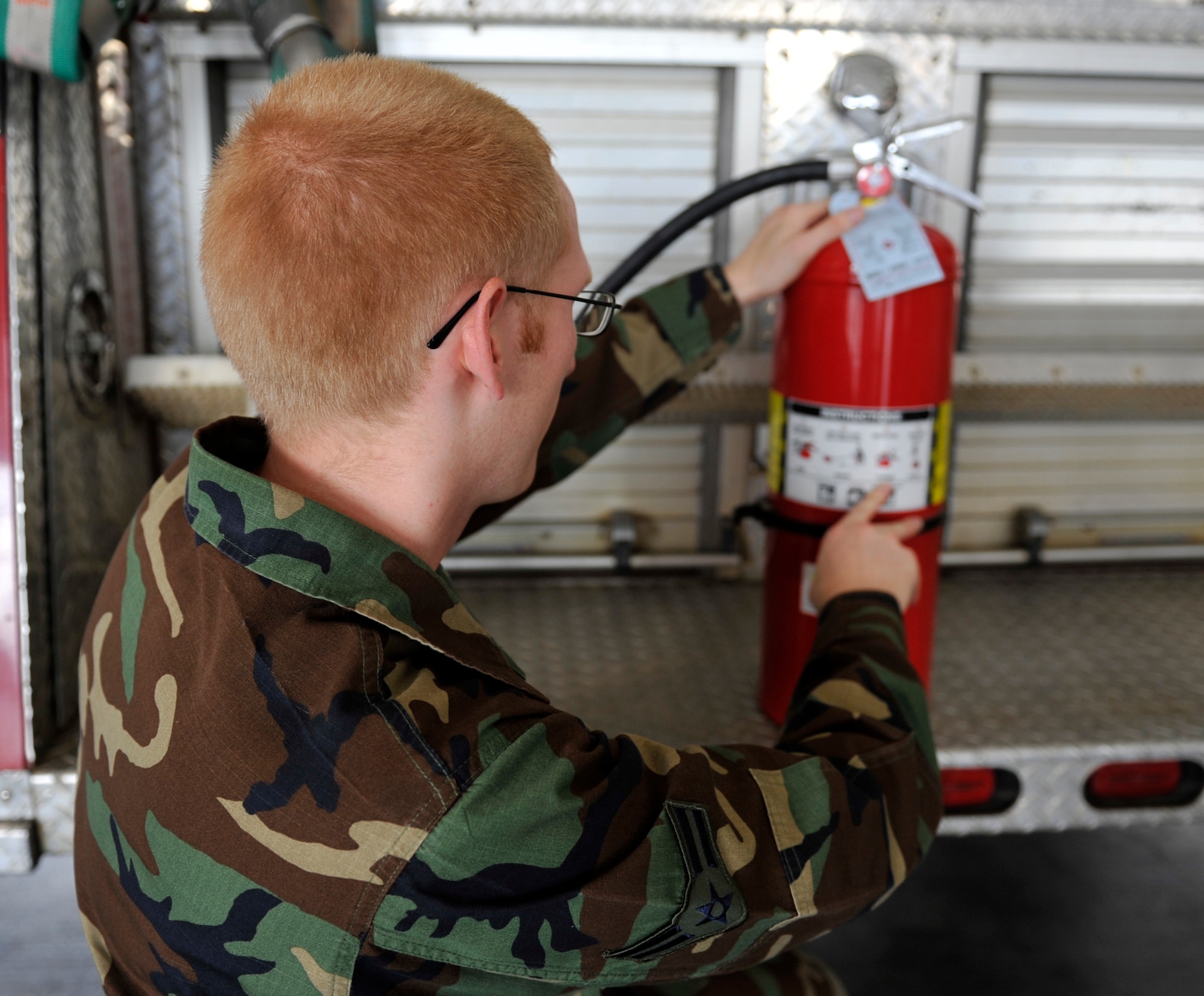 Airman 1st Class Andrew Sloan, 19th Civil Engineering Squadron fire fighter, demonstrates Sept. 21 the proper procedures for using a fire extinguisher on base. Fire extinguishers can put out class A, B, and C fires to include wood and paper, liquid fires and charged electrical fires. (U.S. Air Force photo by Airman 1st Class Lausanne Pacheco)