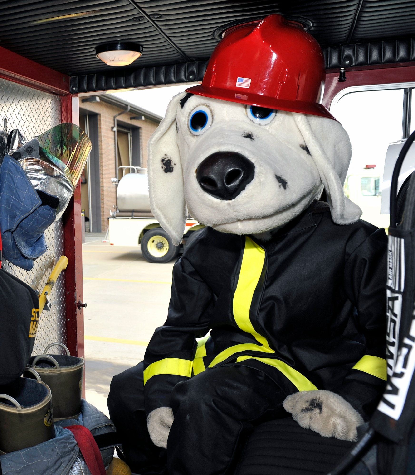 Airman 1st Class Curtis Sinkfield, 19th Civil Engineering Squadron fire fighter, takes time to pose as Sparky inside a fire truck.  The fire truck Sparky’s in is the first fire truck to be called to any fire incident on base. (U.S. Air Force photo by Airman 1st Class Lausanne Pacheco)