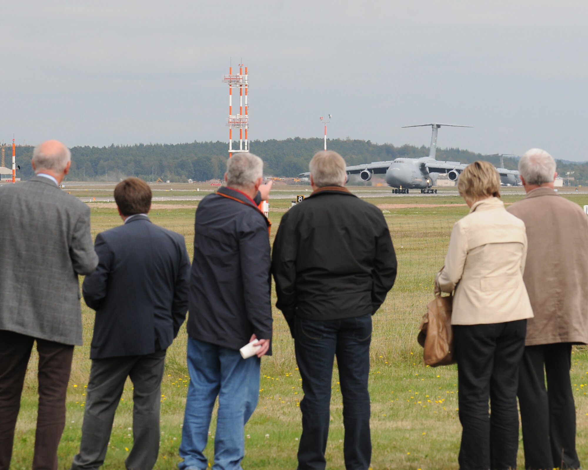 Members from the Combined Noise Abatement Committee and Spangdahlem Air Base, Germany, watch a C-5M acoustic demonstration on Ramstein Air Base, Germany, Sept. 30, 2009.  The CNAC consists of members of the Kaiserslautern Military Community and local German officials who regularly meet to discuss noise abatement issues in the community.  The meeting was followed by a briefing and demonstration that focused on the Air Force’s new C-5M.  Part of the Air Force's continual effort to modernize its inventory, the new model provides increased climb capability and produces less noise when compared to previous C-5 models. Ramstein is a major hub for mobility and airlift operations throughout Europe and downrange, and hosts a variety of other aircraft on its flightline, to include C-5s.  (U.S. Air Force photo by Tech. Sgt. Sean Mateo White)