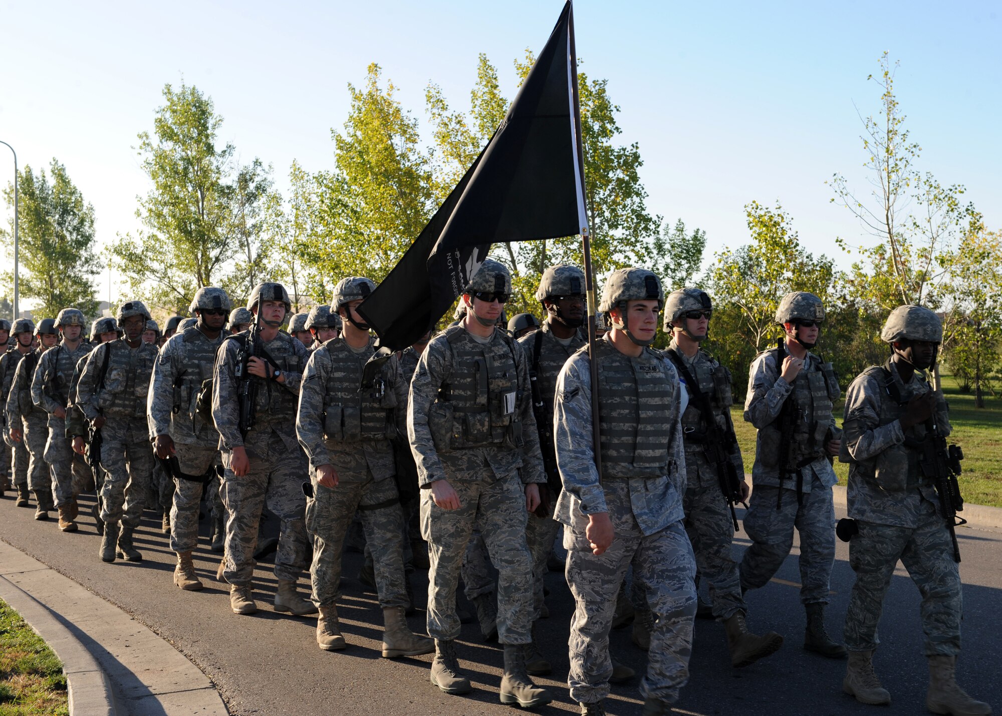 MINOT AIR FORCE BASE, N.D. -- The members of the 5th Security Forces Squadron march in formation and carry the POW/MIA flag to honor the brave men and women who still are missing in action during POW/MIA day here, Sept. 25. POW/MIA day is a day of remembrance for all those who have served our nation’s calling, but not yet returned home. (U.S. Air Force photo by Staff Sgt. Keith Ballard.)