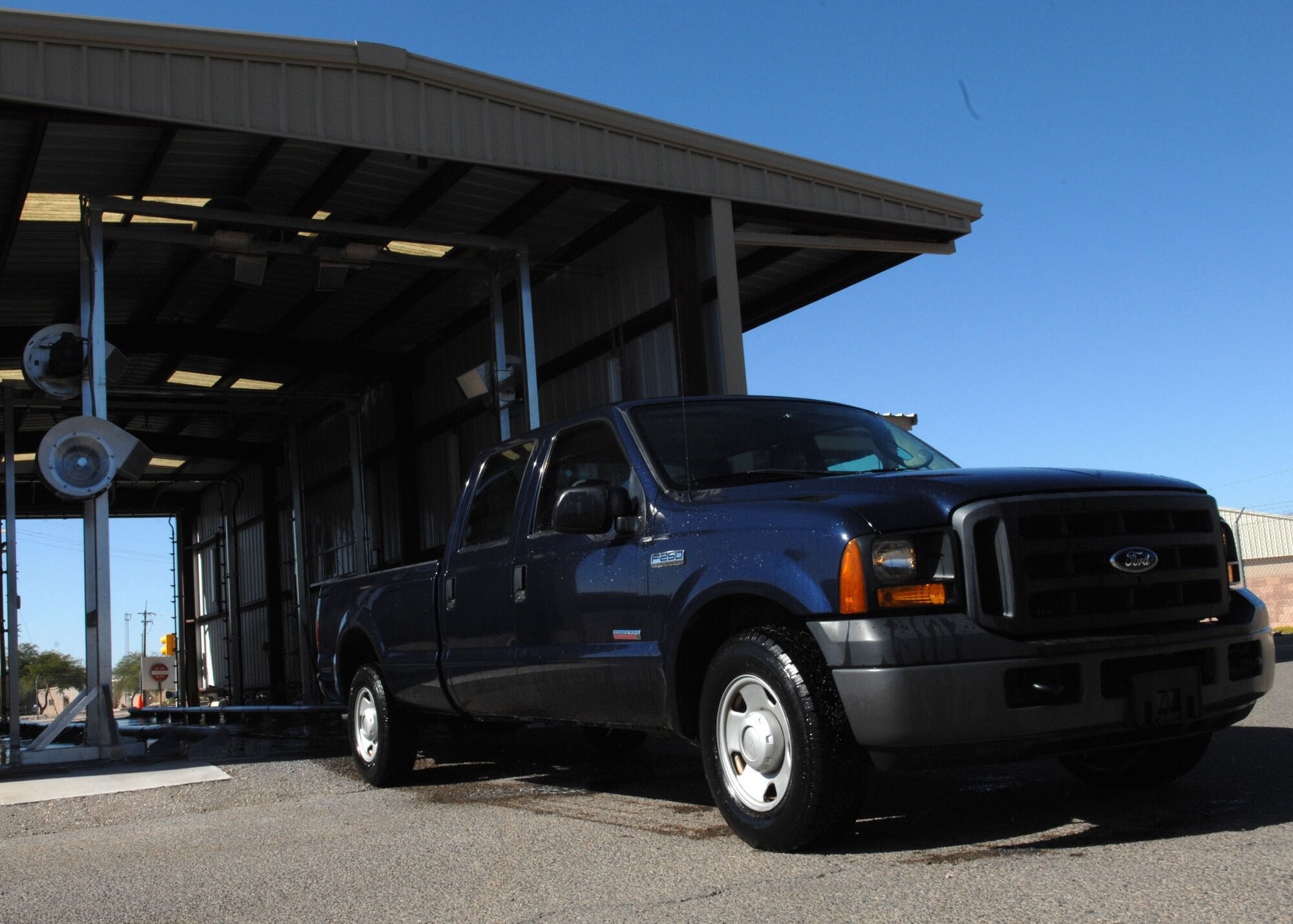 A government vehicle comes out of the new vehicle wash rack facility here Sept. 24. The touch-free vehicle wash rack, which was installed in the vehicle operations compound, is open Monday through Friday from 7 a.m. to 4 p.m. (U.S. Air Force photo: Airman Jerilyn Quintanilla)