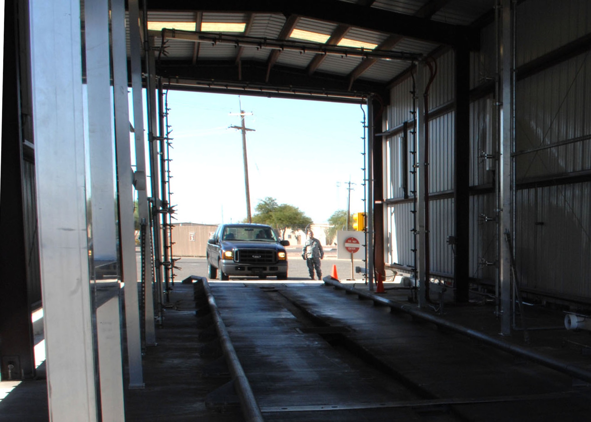 A government vehicle enters the new vehicle wash rack facility here Sept. 24. The vehicle wash rack is beneficial to the base; it conserves water, cleaning supplies and also cuts down on man hours. (U.S. Air force photo: Airman Jerilyn Quintanilla)