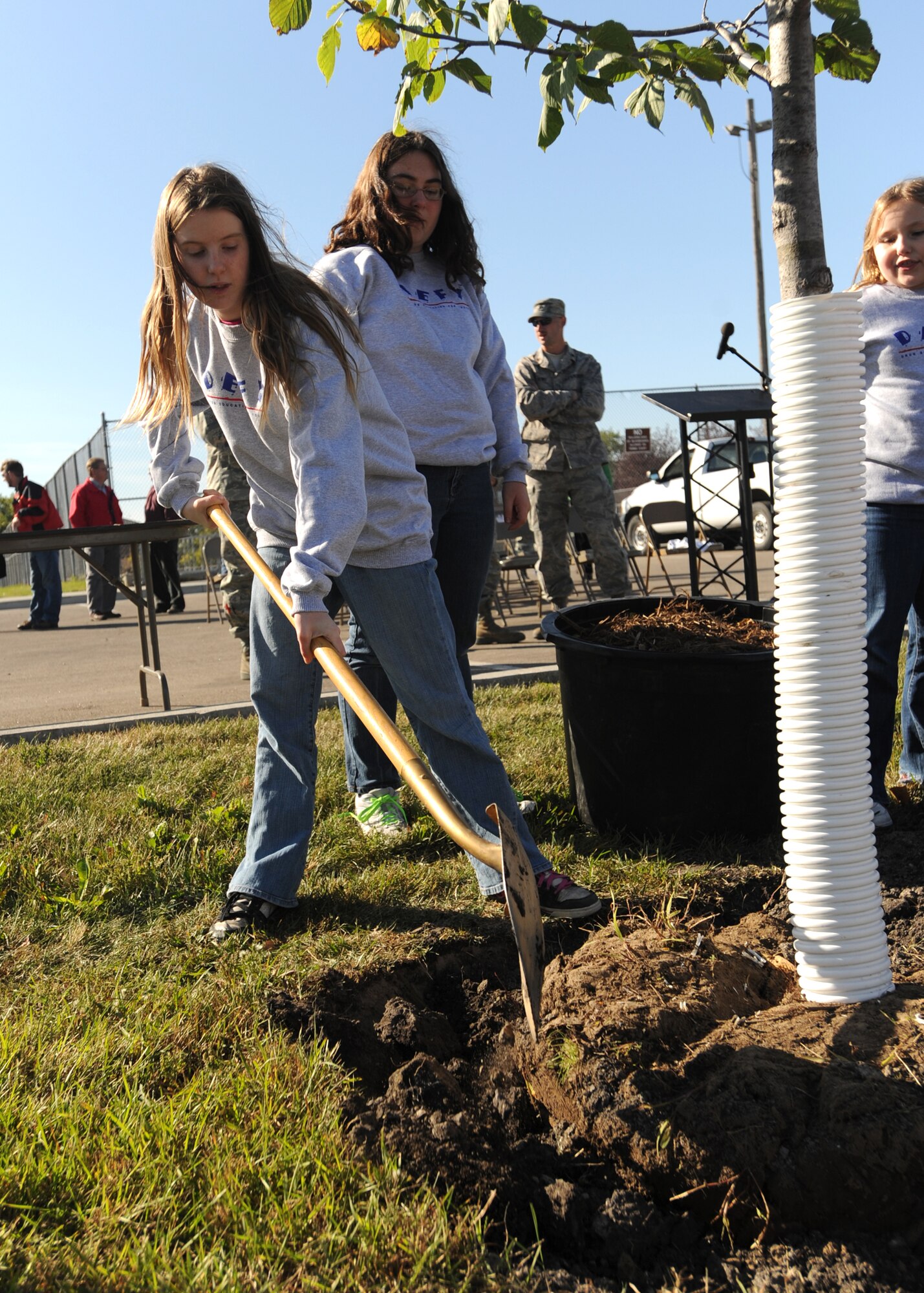 Shanna Nuckolls, daughter of Staff Sgt. Suellyn Nuckolls, 319th Air Refueling Wing Public Affairs, shovels dirt during the 319th ARW’s Arbor Day celebration Sept. 29 on Grand Fork Air Force Base, N.D. (U.S. Air Force photo by Staff Sgt. Suellyn F. Nuckolls)