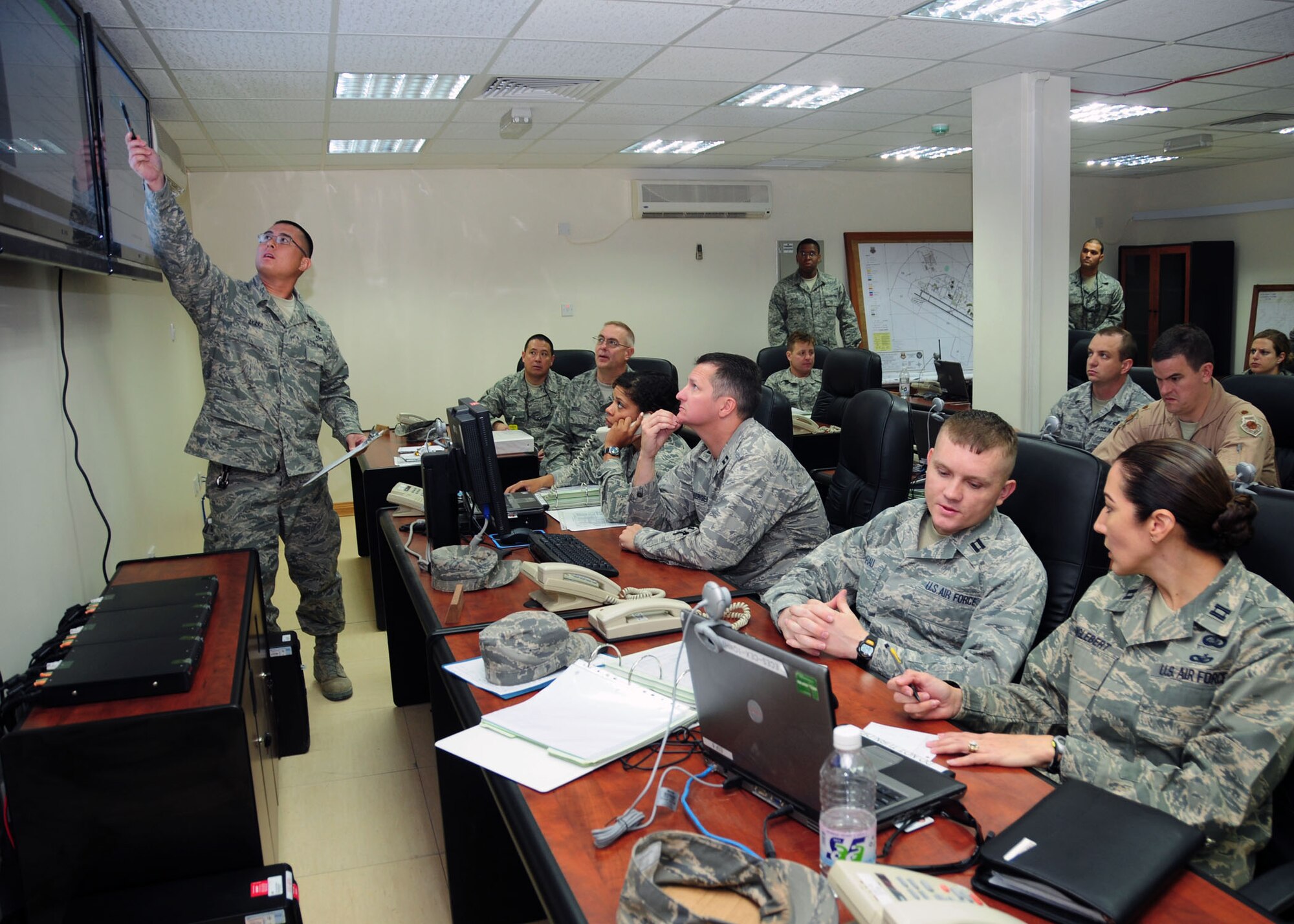 SOUTHWEST ASIA -- Tech. Sgt. Gerard Akaka, 386th Expeditionary Civil Engineering Squadron emergency operations center manager, goes over pandemic plans and emergency support functions at the emergency operations center during a pandemic flu virus exercise held at an airbase in Southwest Asia Sept. 30, 2009.  Sergeant Akaka is deployed from the 154th Wing, Hickam Air Force Base, Hawaii, and hails from Honolulu.  (U.S. Air Force photo/Tech. Sgt. Tony Tolley)