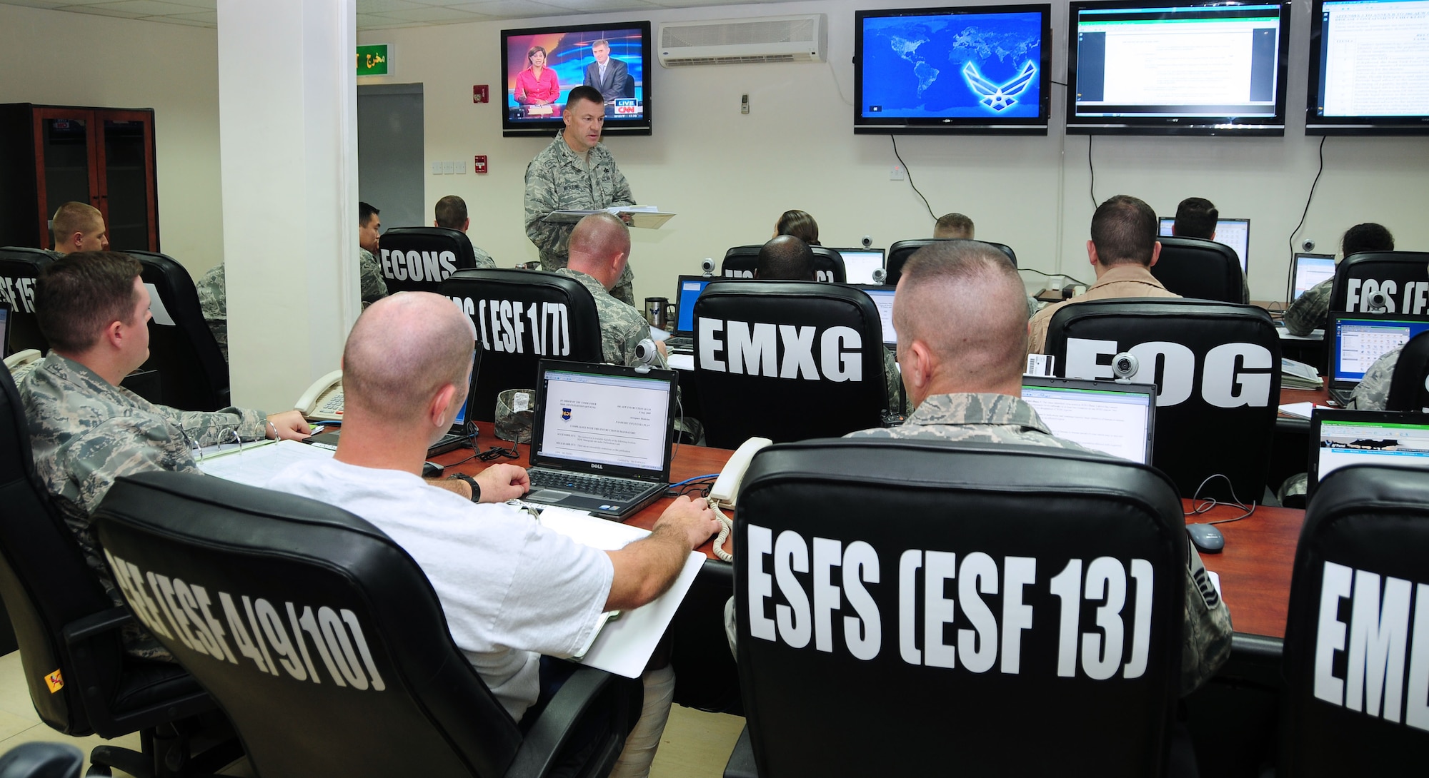 SOUTHWEST ASIA -- Col. Richard McComb, 386th Expeditionary Mission Support Group commander, goes over reporting procedures at the emergency operations center during a pandemic flu virus exercise held at an airbase in Southwest Asia Sept. 30, 2009.  (U.S. Air Force photo/Tech. Sgt. Tony Tolley)