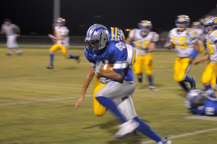 Safety, Reece Washington, a Randolph High School football player picks-up a fumble and runs toward the Randolph end zone.  He is pursued by Blanco High School players. (U.S. Air Force photo by Joel Martinez)