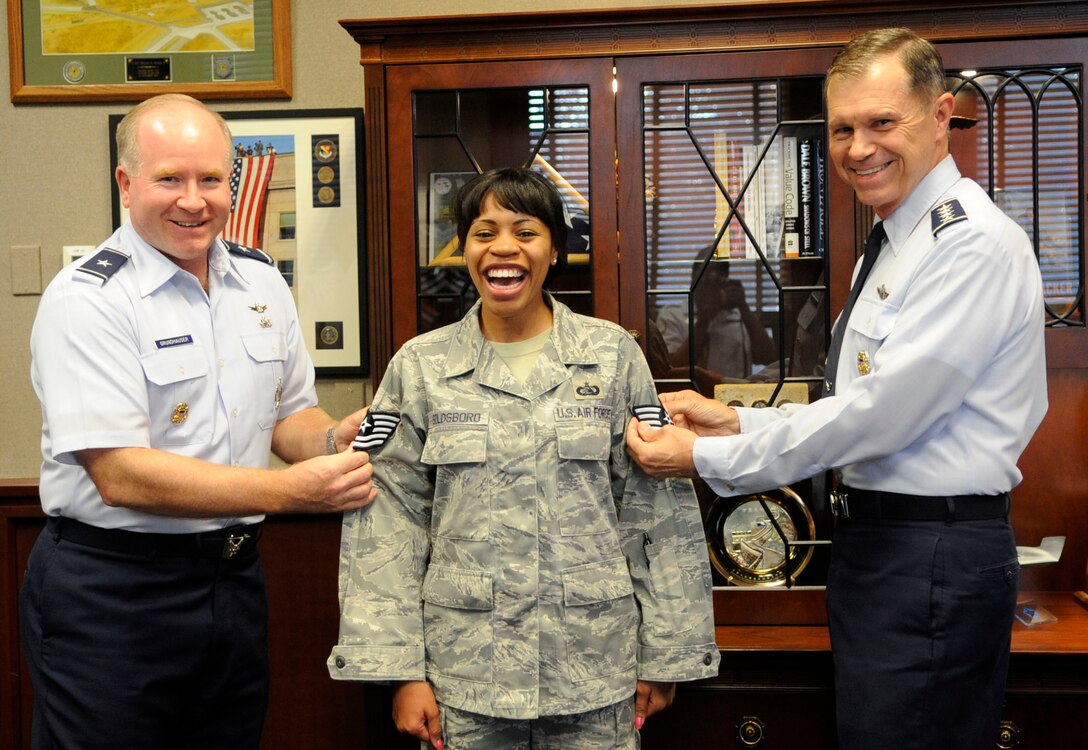 LANGLEY AIR FORCE BASE, Va. -- Gen. William Fraser, Air Combat Command commander, presents new stripes to Tech. Sgt. Shebon Goldsboro, 15th Intelligence Squadron noncommissioned officer-in-charge of system security, with the help
of Brig. Gen. Larry Grundhauser, Headquarters Air Combat Command director of intelligence, here Sept 28. Sergeant Goldsboro was promoted to
technical sergeant under the Stripes for Exceptional Performers program. (U.S. Air Force Photo/Senior Airman Dana Hill)
