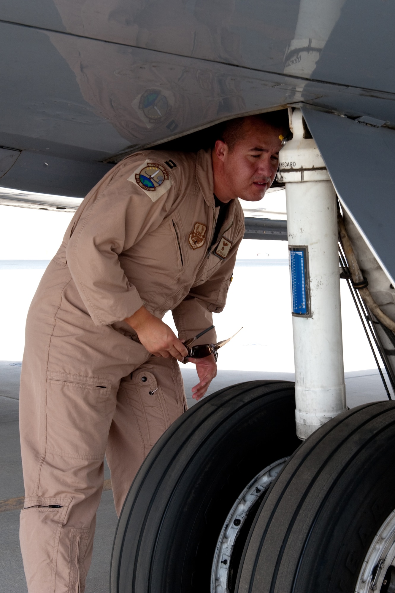 Capt. Jay Trujillo, a C-20H pilot with the 379th Expeditionary Operations Group , visits performs a preflight check of his aircraft prior to taking off on a mission, Sept. 25, in Southwest Asia. Captain Trujillo flies all over the world, supporting airlift missions for high-ranking government and Department of Defense officials. Captain Trujillo is deployed from Ramstein Air Base, Germany, in support of Operations Iraqi and Enduring Freedom. (U.S. Air Force photo/Staff Sgt. Robert Barney) 