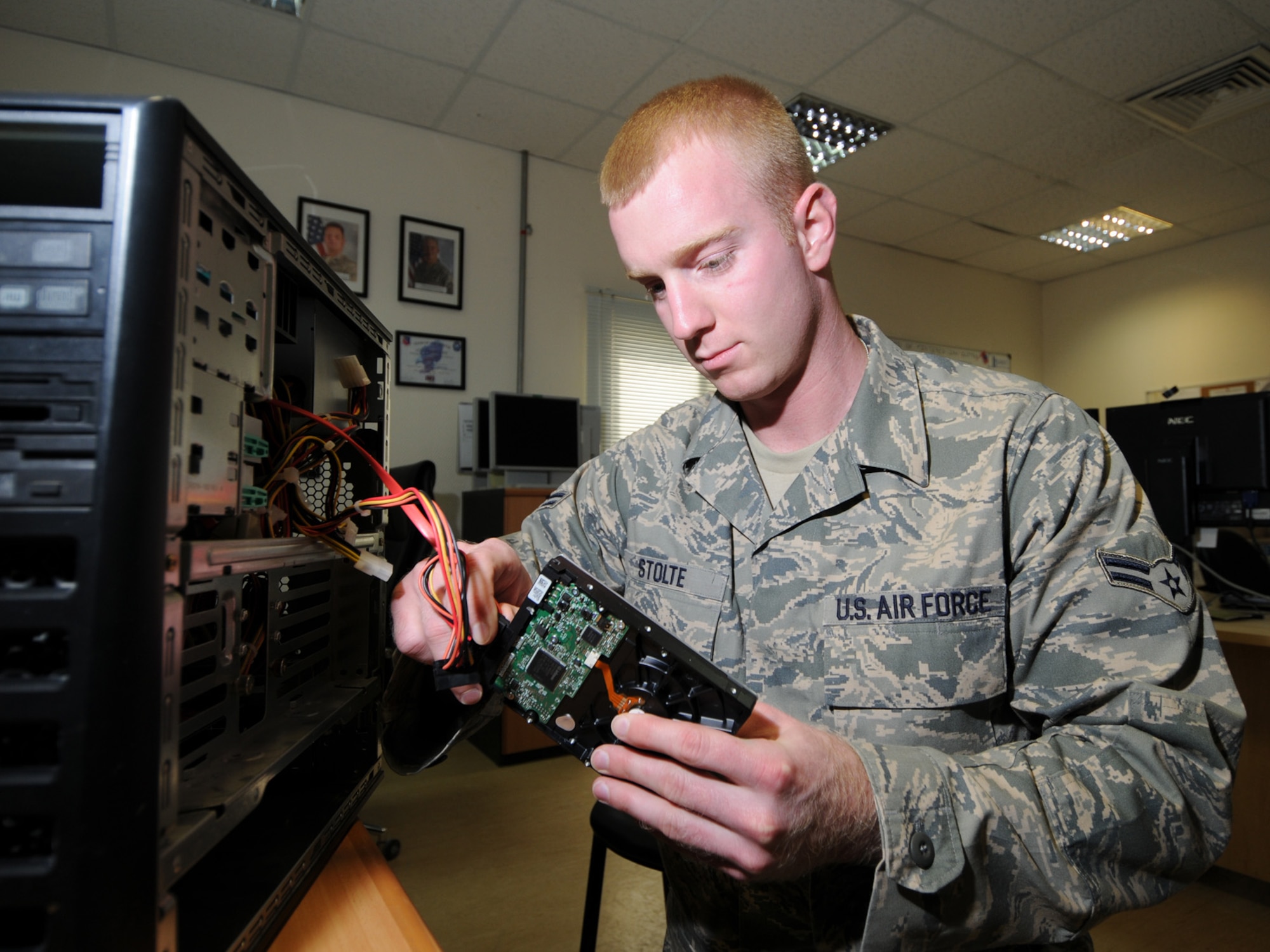Airman 1st Class Todd Stolte, 379th Expeditionary Communications Squadron help desk technician, troubleshoots a computer hardware issue here, Sept. 30. The 379 ECS help desk is the base's one-stop shop for all computer-related issues. Airman Stolte is deployed from Scott Air Force Base, Ill., in support of Operations Iraqi and Enduring Freedom. (U.S. Air Force Photo/Tech. Sgt. Jason W. Edwards)