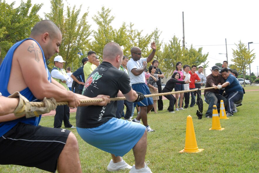KUNSAN AIR BASE, Republic of Korea -- Team 389th Mountain Home pull the rope against the Korean Union team in a tug-of-war event during sports day Sept 29. This morale event included eight teams of eight members trying to pull the opposing team across until the rope marker passes the cone. (U.S. Air Force photo/Staff Sgt. Darnell T. Cannady)