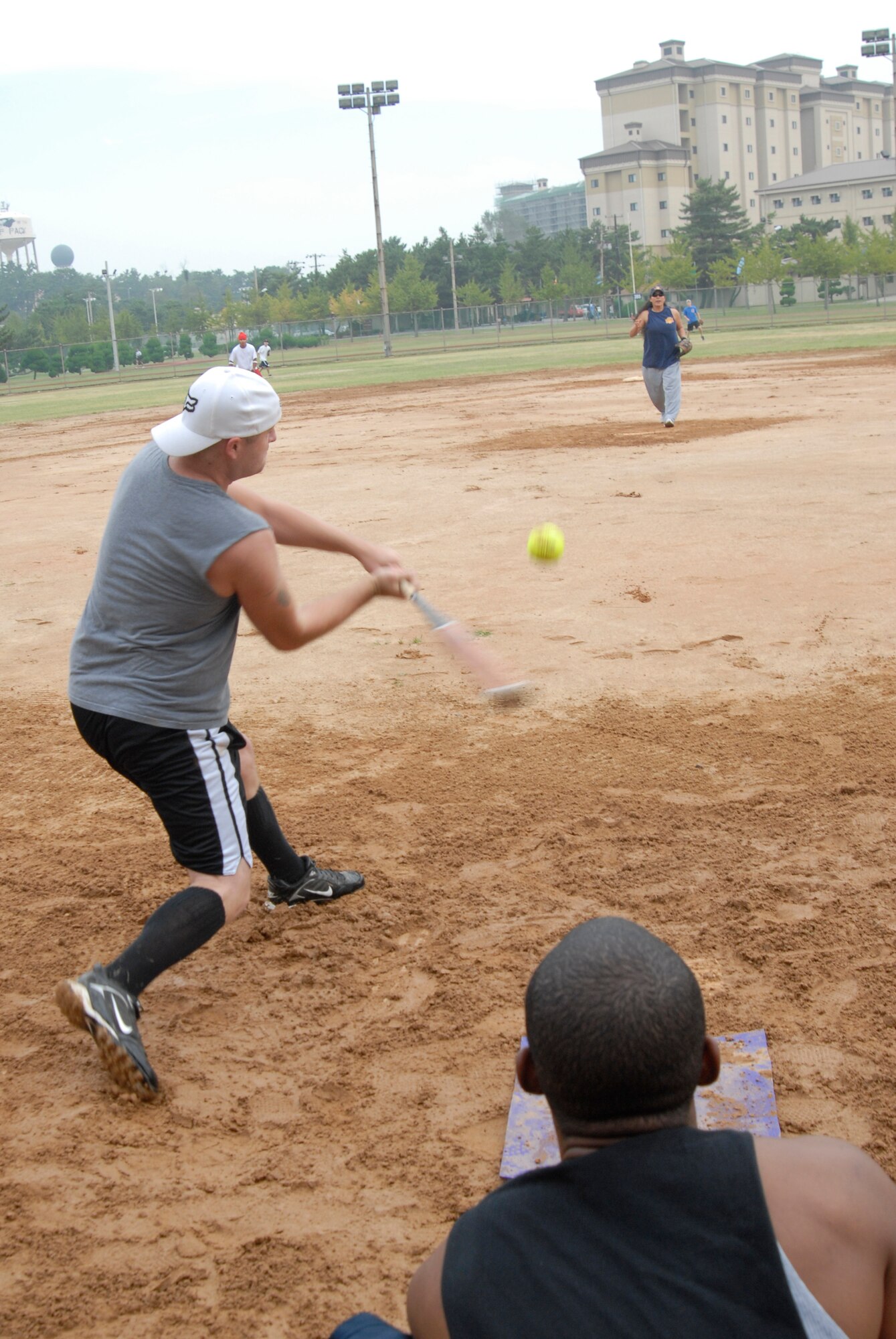 KUNSAN AIR BASE, Republic of Korea -- A member of the 389th Mountain Home team pitches to the batter from the 8th Logistics Readiness Squadron while the catcher awaits the ball during sports day Sept 29. This softball morale event was a single pitch game that lasted three innings. (U.S. Air Force photo/Staff Sgt. Darnell T. Cannady)