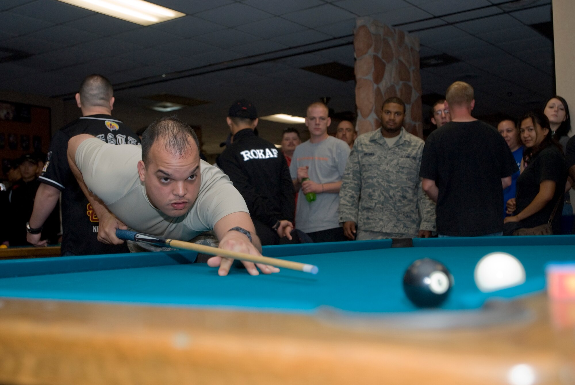 KUNSAN AIR BASE, Republic of Korea ? Staff Sgt. Daniel Cintron, 8th Security Forces Squadron, shoots pool at the 8 ball tournament during the Korean and American friendship and appreciation sports day on Sept. 29. The sports day had various events including softball, basketball and blind volleyball. (U.S. Air Force photo \Senior Airman Jonathan Steffen)