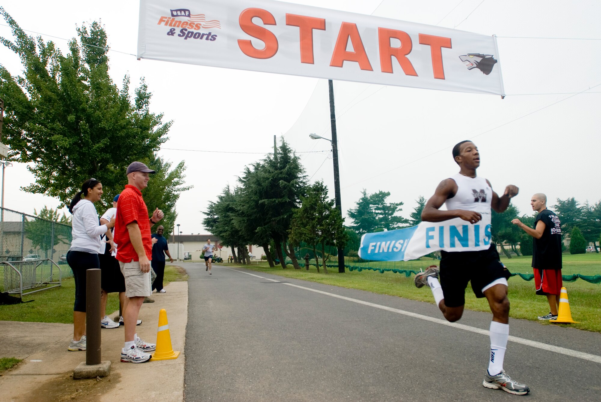 KUNSAN AIR BASE, Republic of Korea -- Airman 1st Class Ahkeem Powell, 8th Logistic Readiness Squadron, finishes first place in the 5k run during the Korean and American Friendship and Appreciation Sports Day Sept. 29. The sports day featured various events including softball, basketball and blind volleyball. (U.S. Air Force photo \Senior Airman Jonathan Steffen)