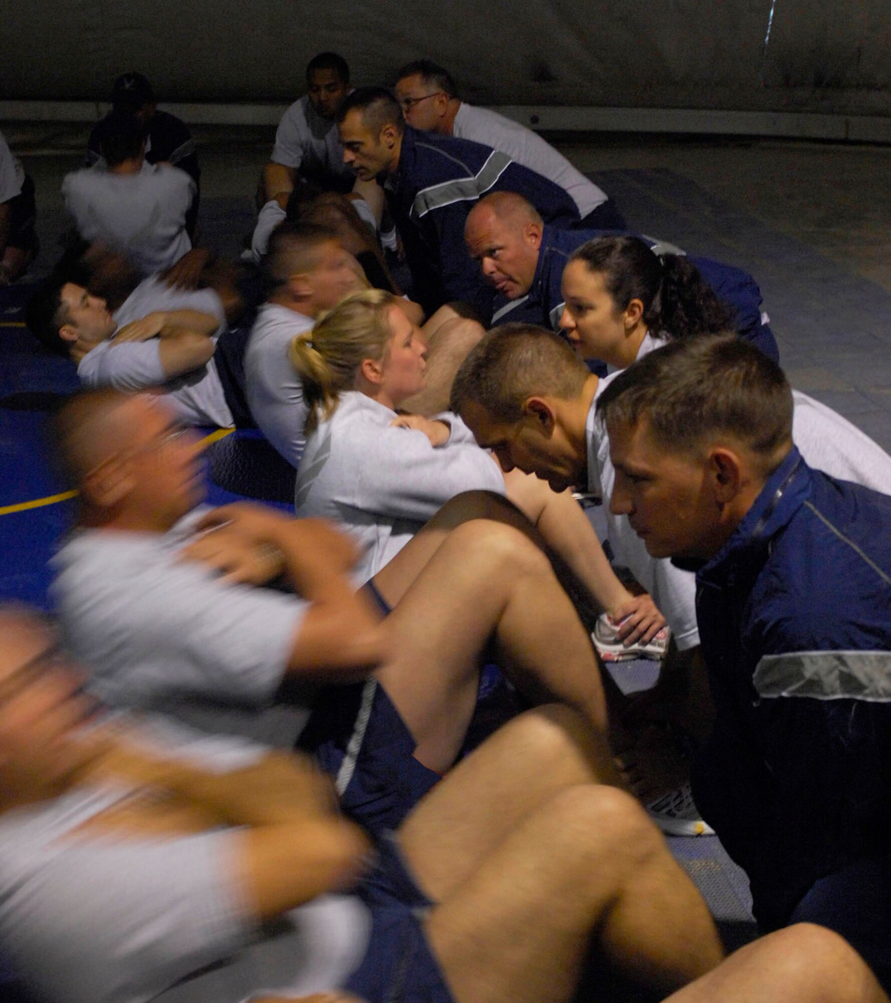 BAGRAM AIRFIELD, Afghanistan -- Airmen assigned to the 455th Air Expeditionary Wing perform sit-ups for a baseline physical fitness test here.  The test was not an official PT test, but rather something Gen. Steven Kwast, 455th AEW commander, wanted his Airmen to have so they could track their progress as they moved through their deployment. (U.S. Air Force photo/Tech. Sgt. John Jung)