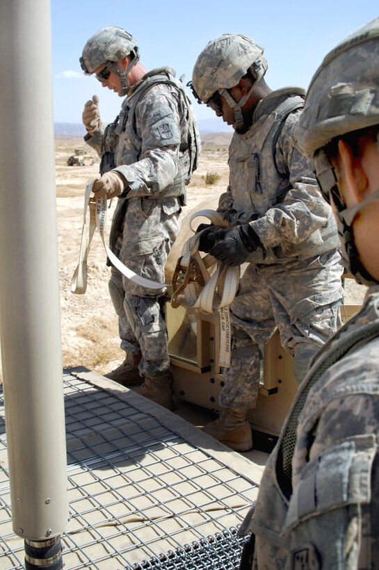 U.S. Army soldiers load HESCO barriers for the construction of a wall near the Iraq-Iran border, Iraq, Sept. 22, 2009. The soldiers are assigned to Company C, 9th Engineer Battalion, and are building the wall near a border patrol station.