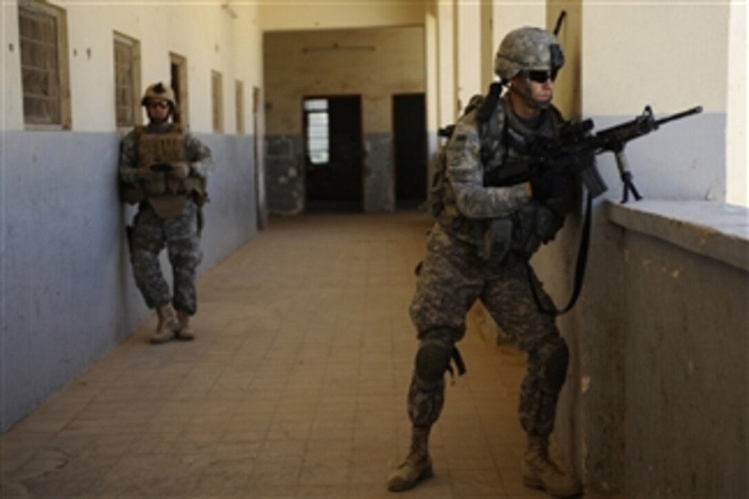A U.S. Army soldier assigned to Bravo Company, 5th Battalion, 20th Infantry Regiment, 3rd Stryker Brigade Combat Team, 2nd Infantry Division provides security during school assessments in the city of Buhriz, Iraq, on Sept. 24, 2009.  
