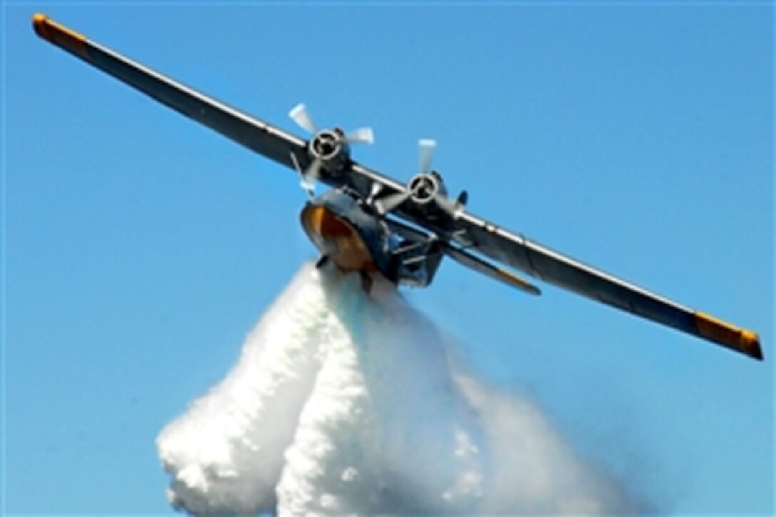 A PBY-6A Catalina, an American flying boat used during World War II and for decades after, drops a load of water from its bomb-bay doors over Crescent Harbor, Wash., Sept. 25, 2009. The aircraft's departure marked the end of a visit to Naval Air Station Whidbey Island and Oak Harbor.