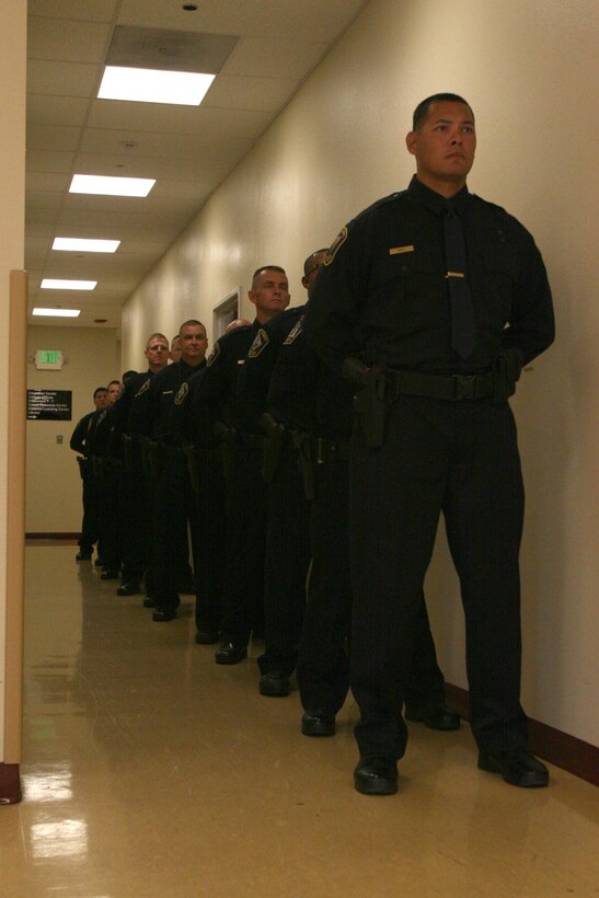 A new class of 13 civilian police line up at the Marine Corps Civilian Police Academy Graduation on Marine Corps Air Station Miramar Sept. 30. The class trained for nine weeks at a regional academy located at MCAS Miramar.