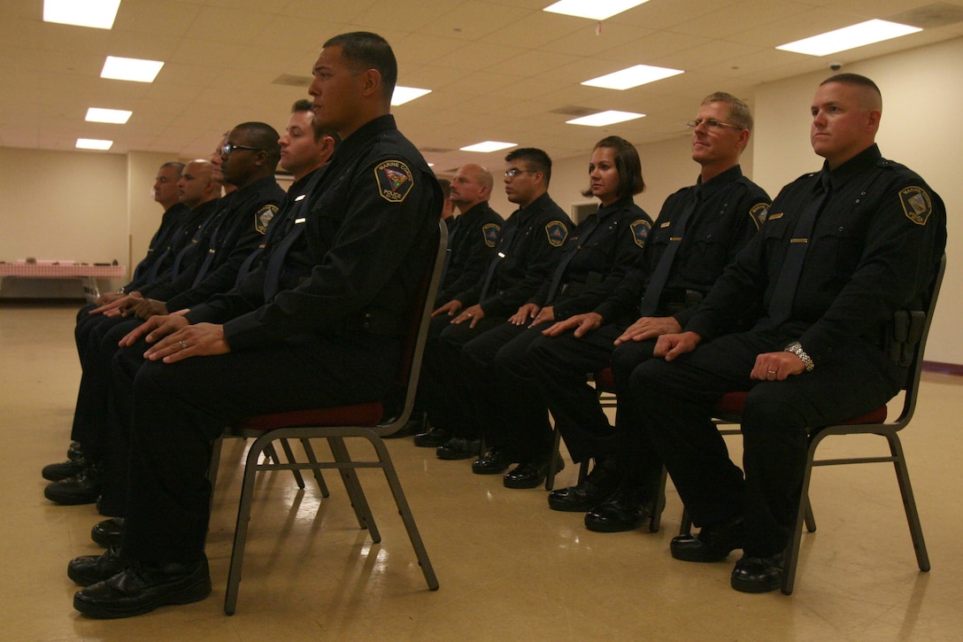 A new class of 13 civilian police sit for comments at the Marine Corps Civilian Police Academy Graduation on Marine Corps Air Station Miramar Sept. 30. The class trained for nine weeks at a regional academy located at MCAS Miramar.