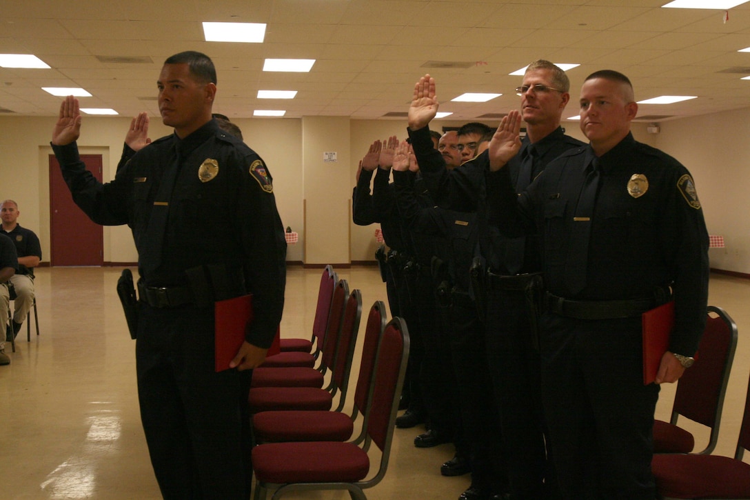 A new class of 13 civilian police swear in at the Marine Corps Civilian Police Academy Graduation on Marine Corps Air Station Miramar Sept. 30. The class trained for nine weeks at a regional academy located at MCAS Miramar.