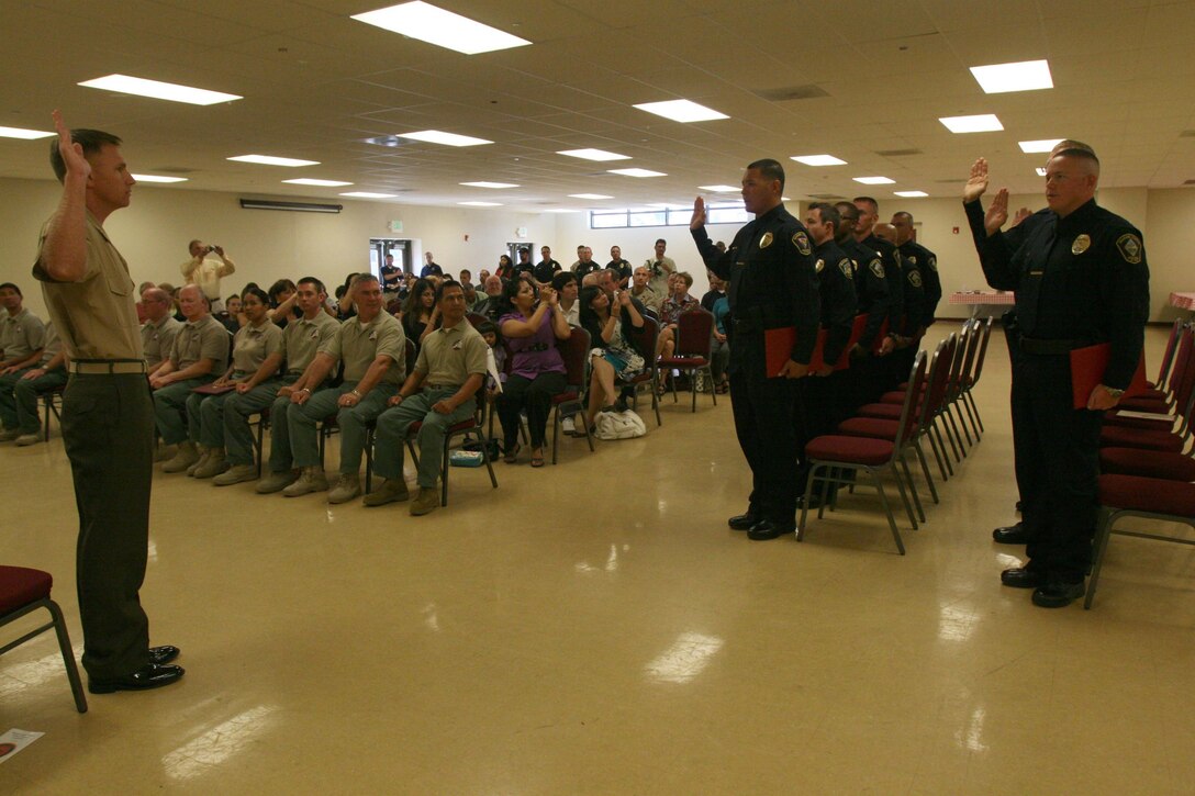 A new class of 13 civilian police swear in at the Marine Corps Civilian Police Academy Graduation on Marine Corps Air Station Miramar Sept. 30. The class trained for nine weeks at a regional academy located at MCAS Miramar.