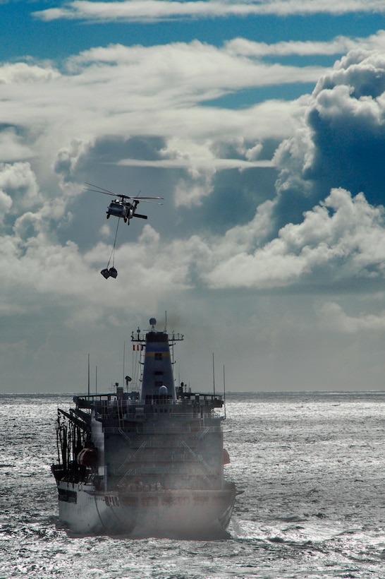 A MH-60S Seahawk carries supplies from fleet replenishment oiler USNS Henry J. Kaiser to USS Bonhomme Richard here Sept. 30 during an underway replenishment. The resupply was the first for Bonhomme Richard since deploying Sept. 24 with more than 1,200 11th Marine Expeditionary Unit members.