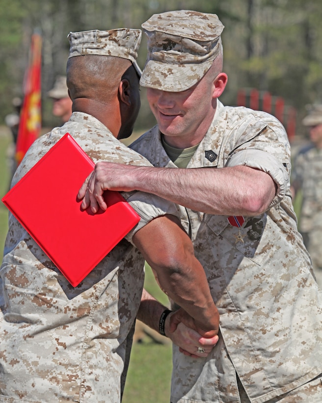 Master Sgt. Christopher W. Burrell, an amphibious assault vehicle crewman with Amphibious Assault Battalion, is congratulated by Marines after receiving the Bronze Star medal on April 1, 2010, aboard Marine Corps Base Camp Lejeune, N.C. In attendance were several retired Marines and sailors from the order of the Purple Heart.