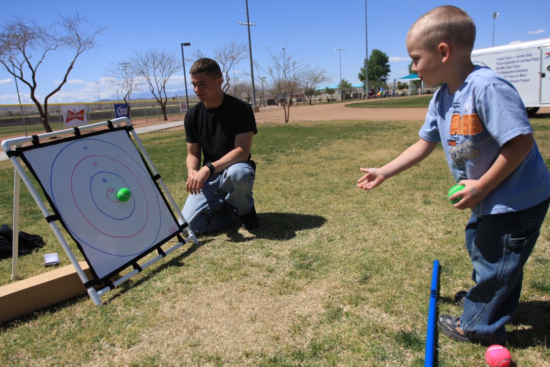 Ethan Dixon, 4, whose father is deployed to Afghanistan with 3rd Battalion, 4th Marine Regiment, hits a bull’s-eye while playing the target game during the Month of the Military Child Carnival April 1 at Felix Field.