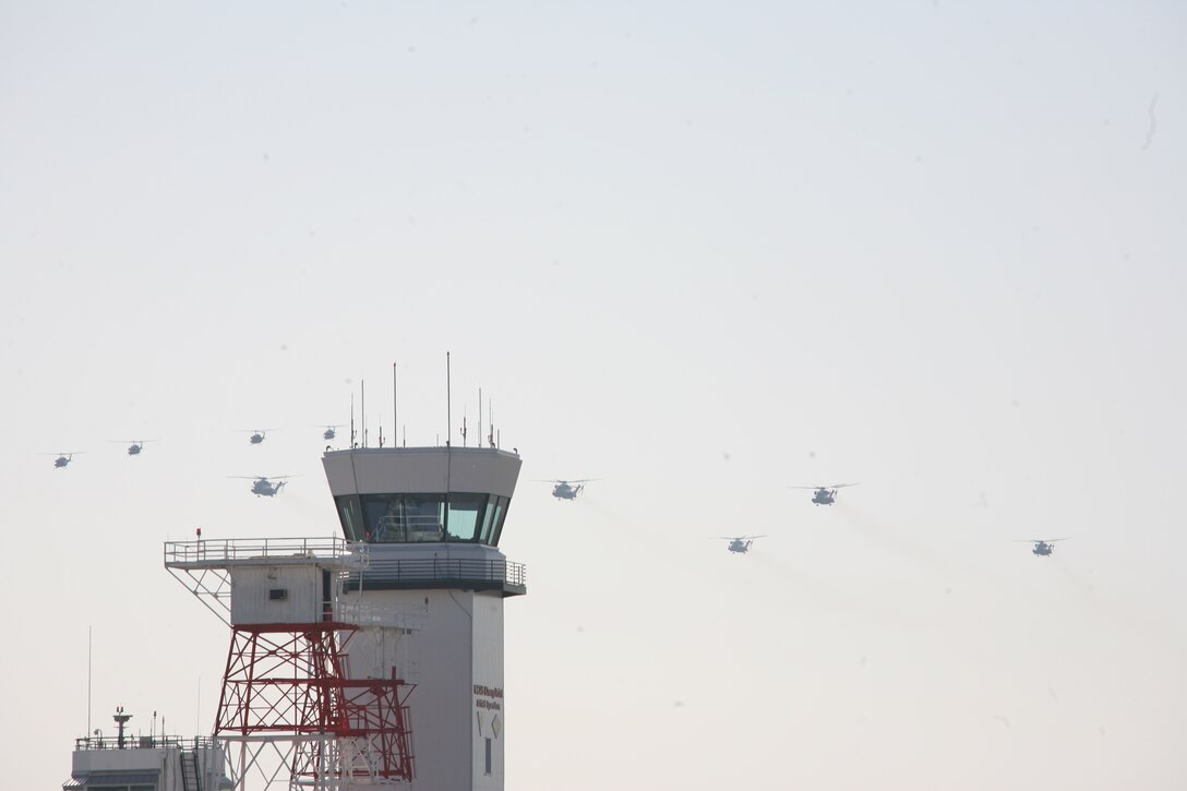 Ten helicopters from Marine Light Attack Helicopter Squadron 467 approach the Marine Corps Air Station Cherry Point tower, April 1, on the return of the squdron to the air station. HMLA-467 was attached to the 22nd Marine Expeditionary Unit to aid and support the people of Haiti following the Jan. 12 earthquake that ravaged the island nation.