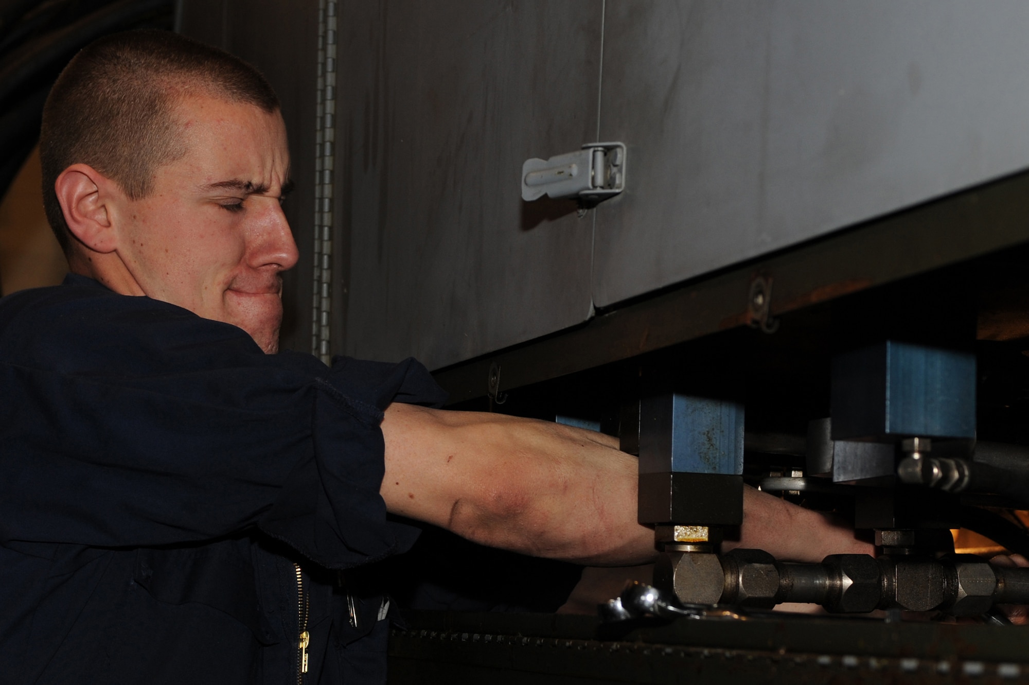 WHITEMAN AIR FORCE BASE, Mo. - Senior Airman Joshua Brymer, 509th Maintenance Squadron aerospace ground equipment technician, strains to tighten a bolt on a mule for maintenance line inspection March 31, 2010. AGE mechanics ensure the equipment is operational to support the daily missions here. (U.S. Air Force photo/Staff Sgt. Jason Huddleston)  (Released)