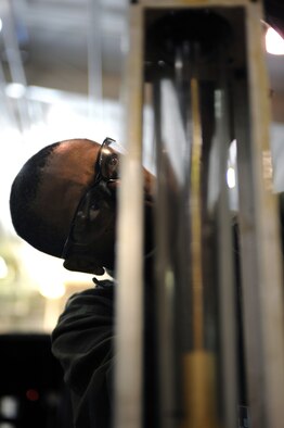 WHITEMAN AIR FORCE BASE, Mo. - Tech. Sgt. John Hamilton, 509th Maintenance Squadron aerospace ground equipment technician, re-assembles  a flow meter for a hydraulic mule March 30, 2010. AGE mechanics ensure the equipment is operational to support the daily missions here. (U.S. Air Force photo/Staff Sgt. Jason Huddleston)  (Released)