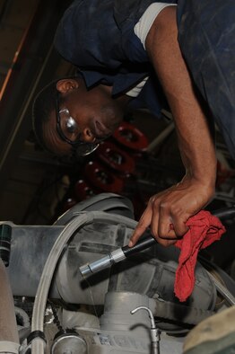 WHITEMAN AIR FORCE BASE, Mo. - Airman 1st Class Joshua Clark,  509th Logistics Readiness Squadron vehicle equipment mechanic, adds oil to a snow broom. The mechanics perform daily maintenance on government vehicles to ensure they are fully operational. (U.S. Air Force photo/Staff Sgt. Jason Huddleston)  (Released)