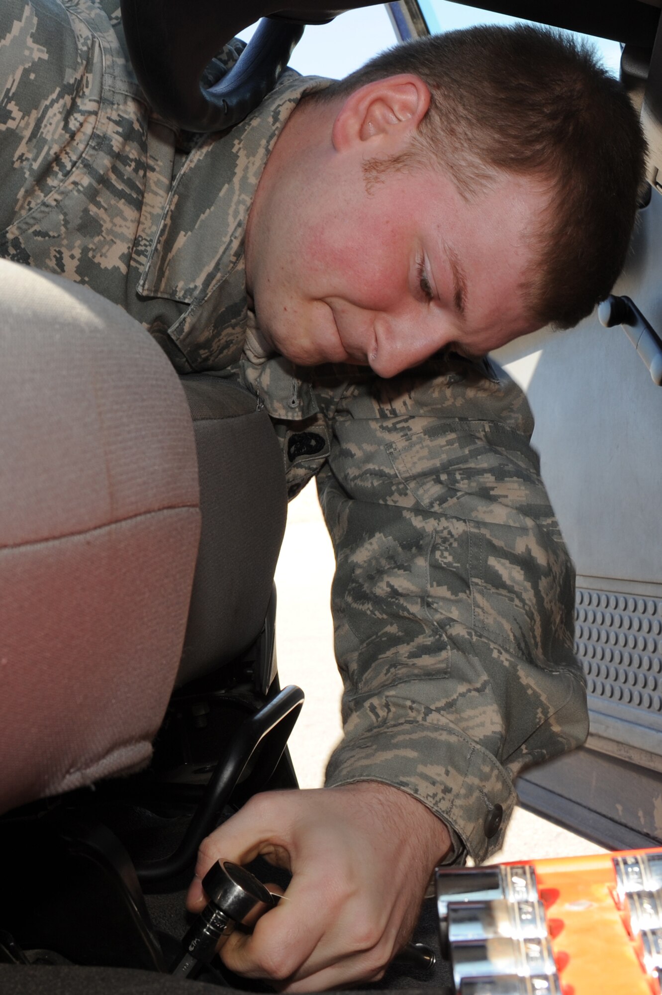 WHITEMAN AIR FORCE BASE, Mo. - Senior Airman Paul White, 509th Logistics Readiness Squadron vehicle equipment mechanic, replaces a seat in a "six-pack" government van. The mechanics perform daily maintenance on government vehicles to ensure they are fully operational. Along with maintenance, mechanics also perform their own upholstery and body work. (U.S. Air Force photo/Staff Sgt. Jason Huddleston)  (Released)