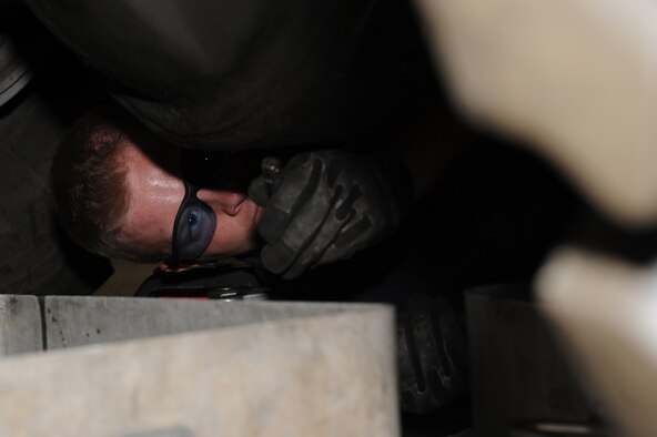 WHITEMAN AIR FORCE BASE, Mo. - Airman 1st Class Timothy Burg, 509th Logistics Readiness Squadron vehicle equipment mechanic, performs an oil change on a snow broom vehicle. The 509th LRS vehicle equipment mechanics, perform daily maintenance on government vehicles to insure they are fully operational. (U.S. Air Force photo/Staff Sgt. Jason Huddleston)  (Released)