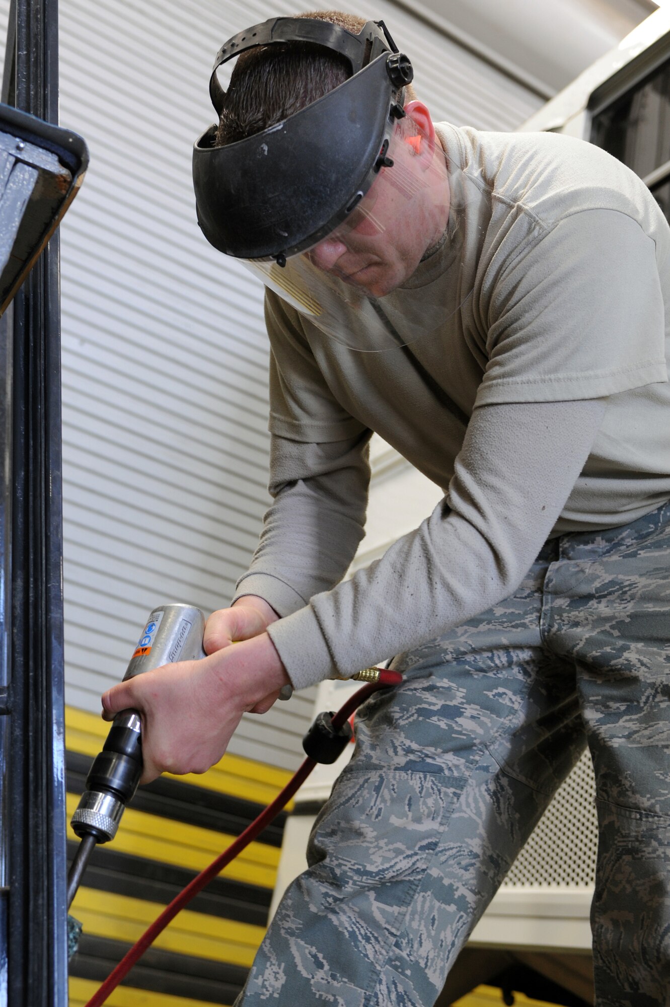 WHITEMAN AIR FORCE BASE, Mo., -- Tech. Sgt. Matthew Damaso, 509th Logistics Readiness Squadron vehicle equipment mechanic, replaces the glass on a front-end loader door. The 509th LRS vehicle equipment mechanics, perform daily maintenance on government vehicles to insure they are fully operational. (U.S. Air Force photo/Staff Sgt. Jason Huddleston)  (Released)