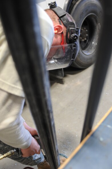 WHITEMAN AIR FORCE BASE, Mo. - Tech. Sgt. Matthew Damaso, 509th Logistics Readiness Squadron vehicle equipment mechanic, replacing glass on a front-end loader door. The 509th LRS vehicle equipment mechanics, perform daily maintenance on government vehicles to insure they are fully operational. Mechanics also perform their own upholstery and body work on government vehicles. (U.S. Air Force photo/Staff Sgt. Jason Huddleston)  (Released)
