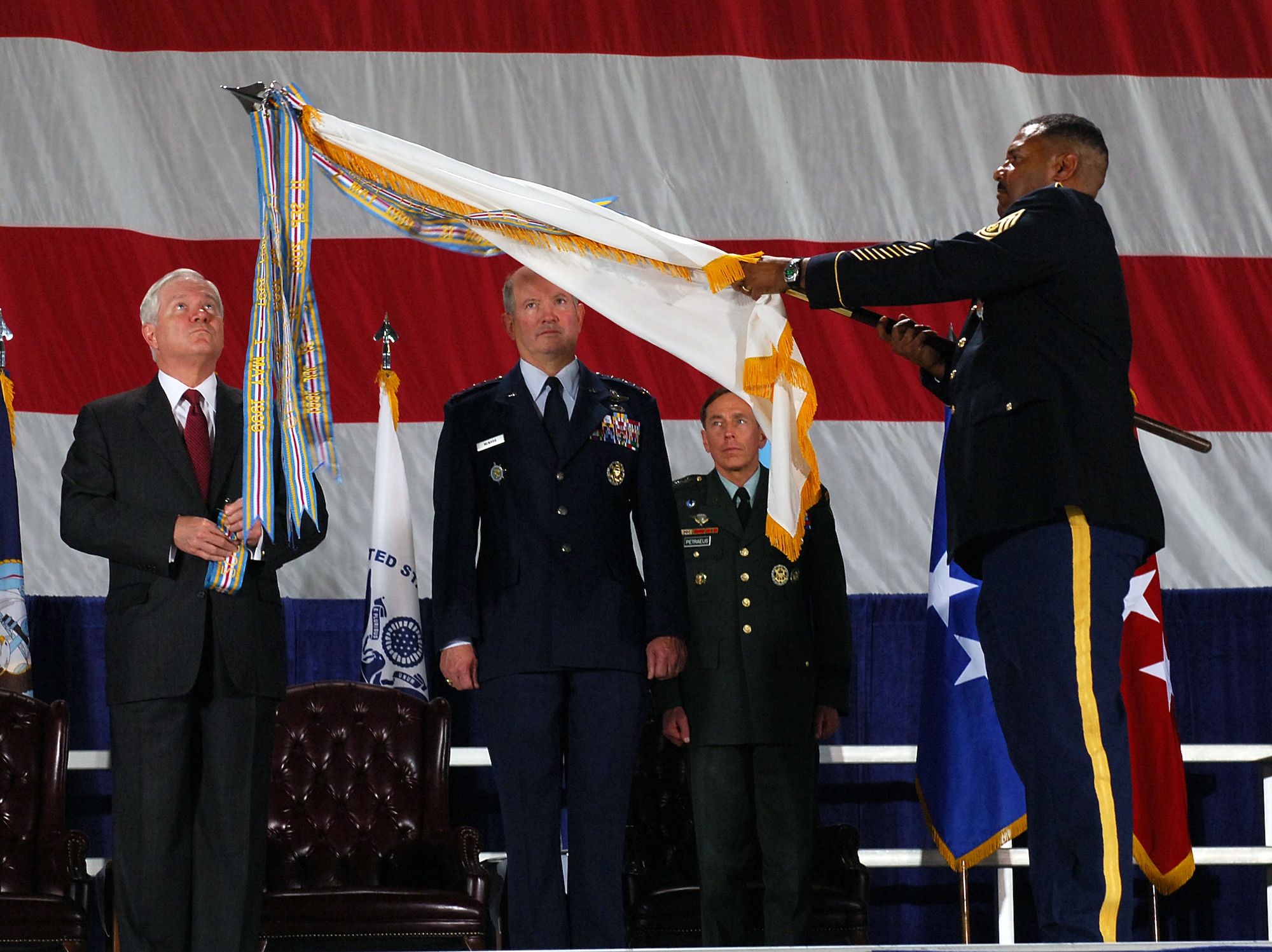 The Honorable Robert Gates, Secretary of Defense, presents the U.S. Transportation Command with the Joint Meritorious Unit Award April 1, 2010. U.S. Transportation Command was awarded this for their outstanding ability to deploy combat troops and supplies to Iraq and Afghanistan while simultaneously providing relief effort in Haiti. (U.S. Air Force photo/ Senior Airman Ryan Crane)