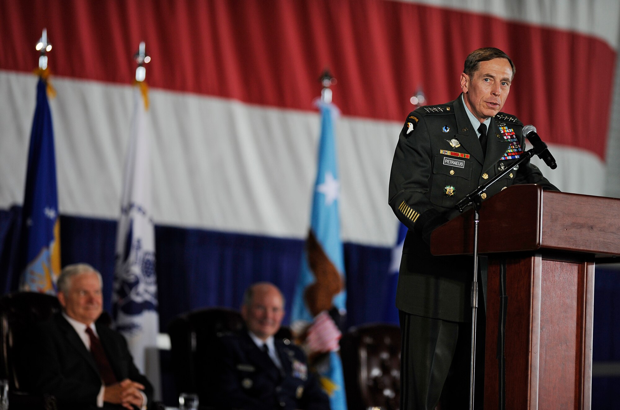 Army General David Petraeus, U.S. Central Command commander, lauds servicemembers of the U.S. Transportation Command for their outstanding performance mobilizing troops and equipment to Iraq and Afghanistan, April 1, 2010. The Honorable Robert Gates, Secretary of Defense, was also in attendance to present the command with the Joint Meritorious Unit Award. (U.S. Air Force photo/ Senior Airman Ryan Crane) 