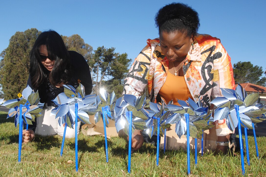 VANDENBERG AIR FORCE BASE, Calif. – Ms. Pauline Chui and Ms. Paula Jacobs, both of the 30th Medical Operations Squadron, set up the Pinwheels for Change garden display at the main gate here Thursday, April 1, 2010. The display is designed to provide a visual representation of April’s child abuse prevention theme. (U.S. Air Force photo/Senior Airman Christopher Hubenthal)