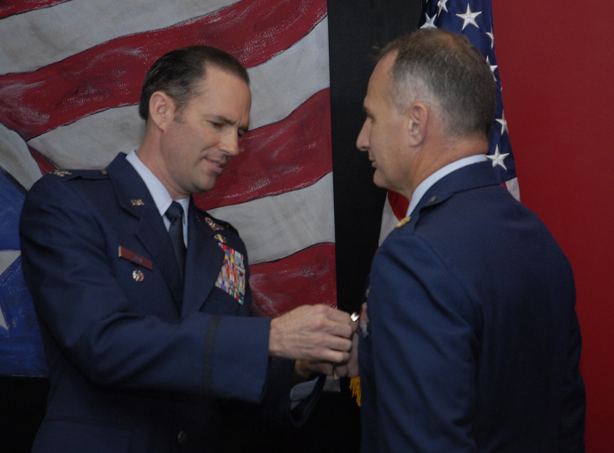 Col. Daniel Zook, 1st Special Operations Wing vice commander, left, pins a Bronze Star Medal to Maj. Mark Durkin, 1st Special Operations Support Squadron assistant operations officer, at the 1st SOSS at Hurlburt Field Apr. 1. Major Durkin, later promoted to lieutenant colonel during the same ceremony, served as officer-in-charge of a temporary screening facility for a joint task force in support of Operation Iraqi Freedom from Aug. 20, 2008 to March 10, 2009. (U.S. Air Force photo by Airman 1st Class Joe McFadden)