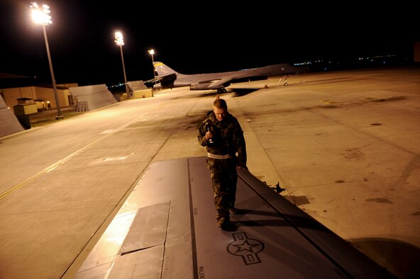 ELLSWORTH AIR FORCE BASE, S.D -- Senior Airman Scott Foust, 28th Aircraft Maintenance Squadron crew chief, inspects a B-1B Lancer wing for structural damage, March 31. Crew chiefs send the B-1 into flight and recover every sortie flown at Ellsworth. (U.S. Air Force photo/Airman 1st Class Corey Hook)